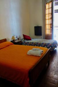 a bedroom with two beds with towels on them at Hotel Bahia in Buenos Aires