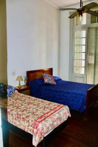 a bedroom with two beds and a window at Hotel Bahia in Buenos Aires