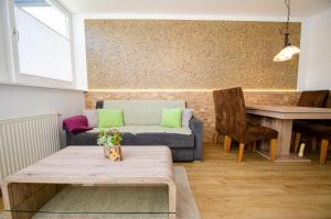 a living room with a couch and a table at Apartment Nature & Friends in Piesendorf