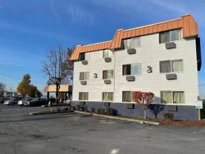 a large white building with a red roof at Portland Inn in Portland