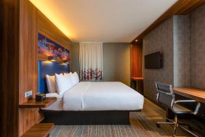 a hotel room with a bed and a desk at Sky Loft Hotel Kyiv by Rixwell International in Kyiv