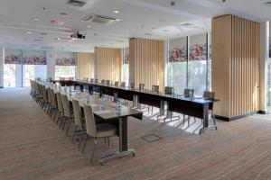 a large conference room with a long table and chairs at Sky Loft Hotel Kyiv by Rixwell International in Kyiv