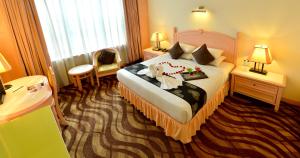 Voodi või voodid majutusasutuse Emerald Puteri Hotel toas