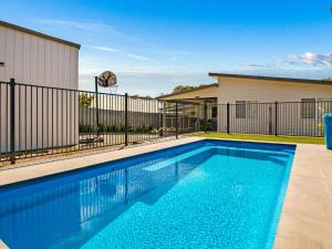 a swimming pool in front of a building at A Perfect Ten in Cowes