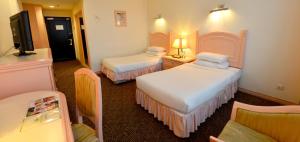 Voodi või voodid majutusasutuse Emerald Puteri Hotel toas
