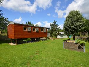 a tiny house on a trailer in a yard at Charming Holiday Home in Malmedy with Sauna in Malmedy