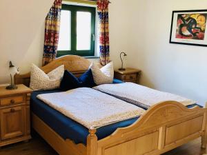 a bedroom with a wooden bed with blue sheets at Elegant Mansion in Barlin with Swimming Pool in Barlin