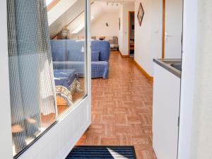 a living room with a blue couch and a table at Magnificent flat with garden in Saint R my in Clécy