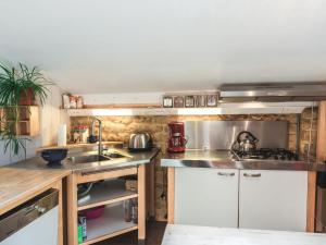 a kitchen with a sink and a counter top at Comfortable cottage in Lamorteau with garden in Lamorteau