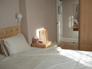 
a bedroom with a bed and a dresser at Invernook in Newquay
