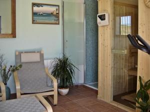 a room with a chair and a walk in shower at Holiday Home Finca Retama in Ronda
