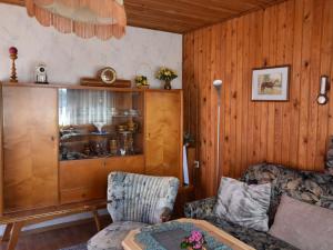 a living room with a couch and a table at Cozy bungalow near the beach in Kühlungsborn