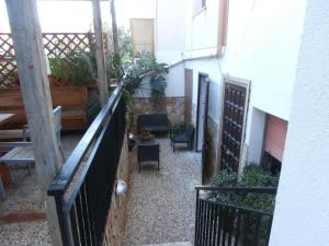 a balcony of a building with chairs and plants at Busalacchi B&B in Mondello