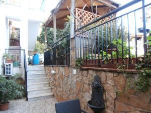 a house with a stone wall and a staircase at Busalacchi B&B in Mondello