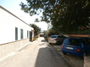 a street with two cars parked next to a building at Busalacchi B&B in Mondello
