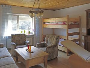 a living room with a bunk bed and a couch at Modern Apartment in H ddingen with Terrace in Bad Wildungen