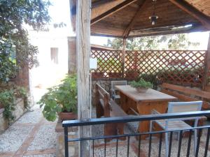 a wooden gazebo with a table and chairs at Busalacchi B&B in Mondello