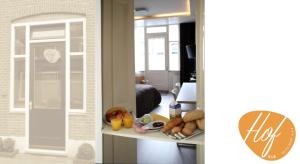 
a kitchen with a refrigerator and a window at Hof, a luxury B&B in the center of Eindhoven in Eindhoven
