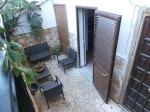 a room with a door and chairs and a table at Busalacchi B&B in Mondello