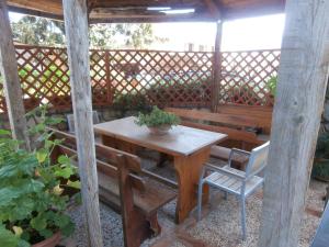 a wooden table and chairs on a patio at Busalacchi B&B in Mondello