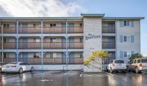 a large apartment building with cars parked in a parking lot at Calypso at Nautilus - Pet Friendly, Walk to beach! in Ocean Shores