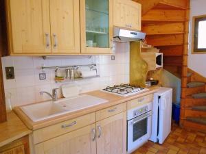 a kitchen with a sink and a stove at The ideal chalet for a relaxing holiday in the mountains in Celliers
