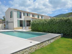 a villa with a swimming pool and a house at Superb villa with heated pool in Malauc ne in Malaucène
