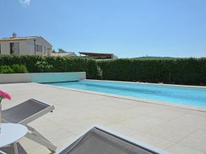 a swimming pool in the backyard of a house at Vibrant Villa in Malauc ne with Private Garden in Malaucène