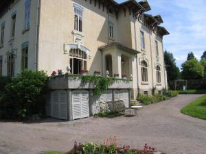 a building with a bench in front of it at Delightful Mansion in Vecoux with Garden in Vecoux