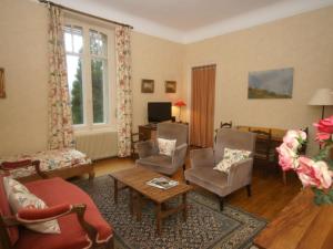 a living room with a couch and chairs at Delightful Mansion in Vecoux with Garden in Vecoux