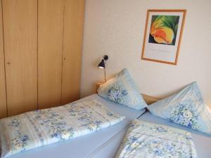 a bedroom with two beds with blue and white pillows at Apartment-3 in Schönhagen
