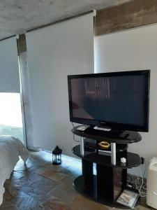 a television sitting on a table in a room at Loft del barranco in Colonia del Sacramento