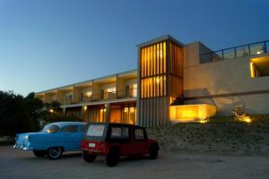an old car parked in front of a building at La Viuda de José Ignacio in José Ignacio