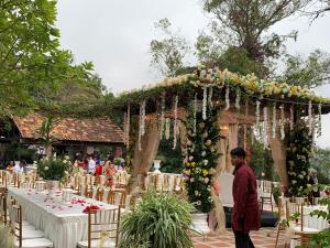 a man standing in front of a wedding altar at The Bala's Holiday Chalet in Cameron Highlands