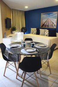 a living room with a table with chairs and a couch at Ana marinho flat 702 in Natal