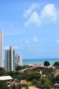 a view of a city with buildings and the ocean at Ana marinho flat 702 in Natal
