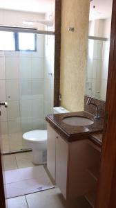 a bathroom with a sink and a toilet and a mirror at Ana marinho flat 702 in Natal