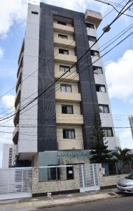 a tall building with a sign on it at Ana marinho flat 702 in Natal