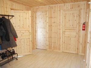 a room with wooden walls and two doors at Chalet in Torsby Municipality Middle with Sauna in Gunsjögården