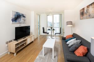 a living room with a couch and a flat screen tv at Brightleap Apartments - The Hub in Milton Keynes