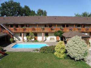 a house with a swimming pool in front of it at Jihočeský Statek in Dynín