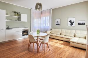 sala de estar con sofá, mesa y sillas en Lapilanoa - Suite & Pool, en Nardò