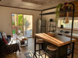 a kitchen with a large island in a room at Guest House KOKORO in Yamanakako