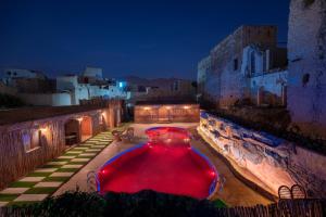 a swimming pool in the middle of a building at night at Antique Inn in Nizwa