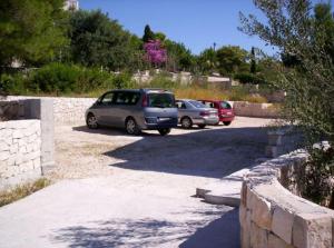 a group of cars parked in a parking lot at Villa Adagio Apartments in Sumartin