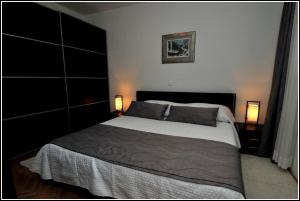 een slaapkamer met een groot bed en 2 lampen bij Apartment Karmen in Dubrovnik