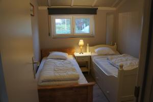 two beds in a small room with a window at Duinenhuis Zeepolder 27 in De Haan +39 photos