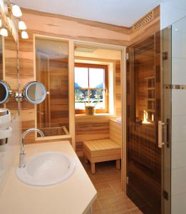 a bathroom with a sink and a shower at Landhaus Katharina in Ramsau am Dachstein