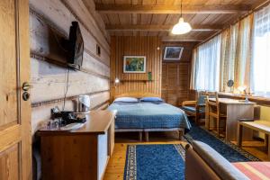 a bedroom with a bed and a table in a room at Willa Koisowka in Zakopane