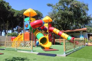 a playground with a slide in a park at Campeggio Italia in Marina di Massa